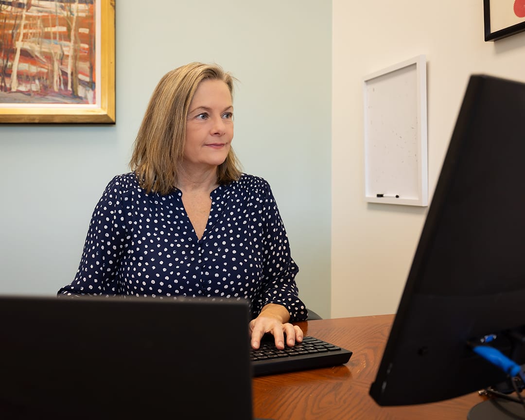 karen working at desk on computer