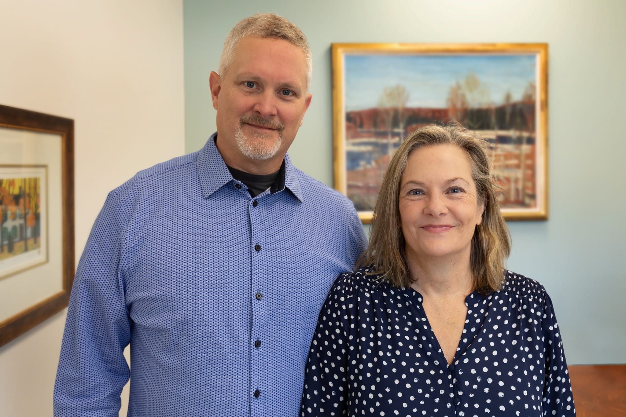 Paul and Karen standing in office